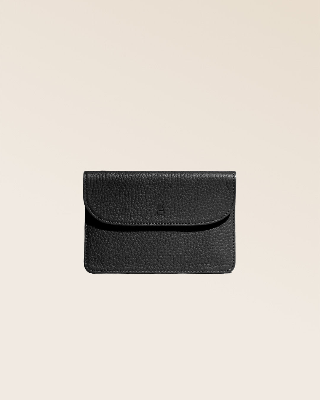 Our Aurore paperweight in black vicuña-style leather, seen from the front in the studio.