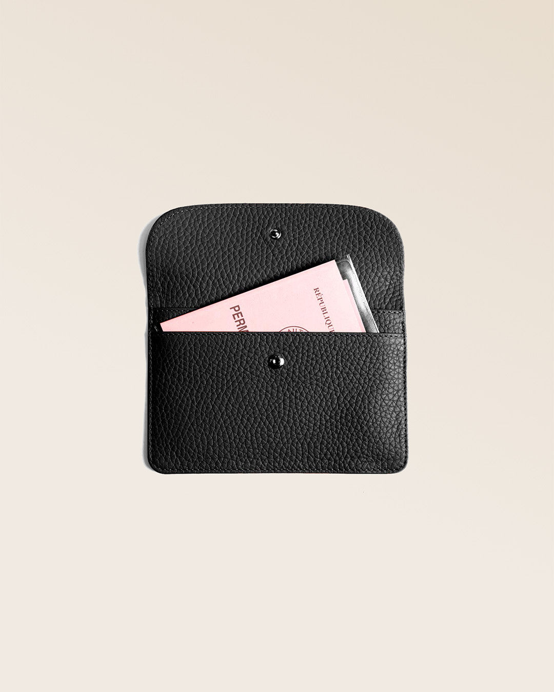 Our Aurore paperweight in black vicuña-style leather, seen from the front in the studio.