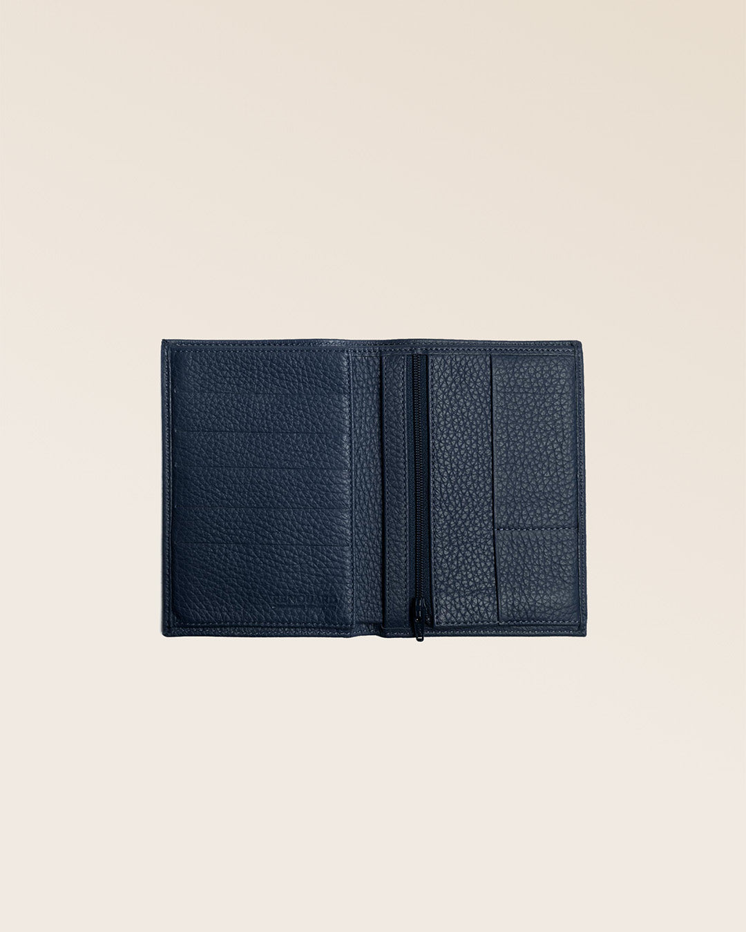 Our navy blue vicuña-style leather Papiers wallet seen partially opened in the studio.