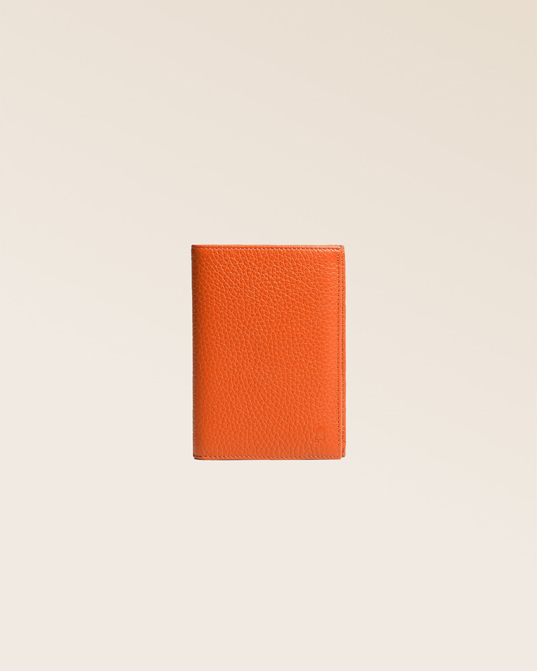 Our Papiers wallet in orange vicuña-style leather, seen from the front in the studio.