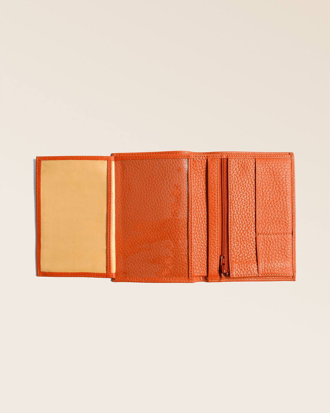 Our Papiers wallet in orange vicuña-style leather, seen fully opened in the studio.