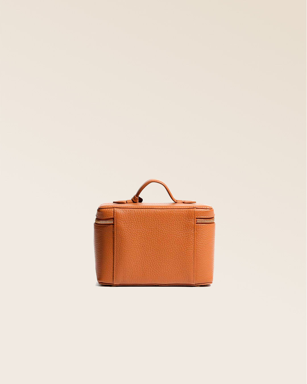 Our little tan vicuña-style leather vanity seen from behind in the studio.
