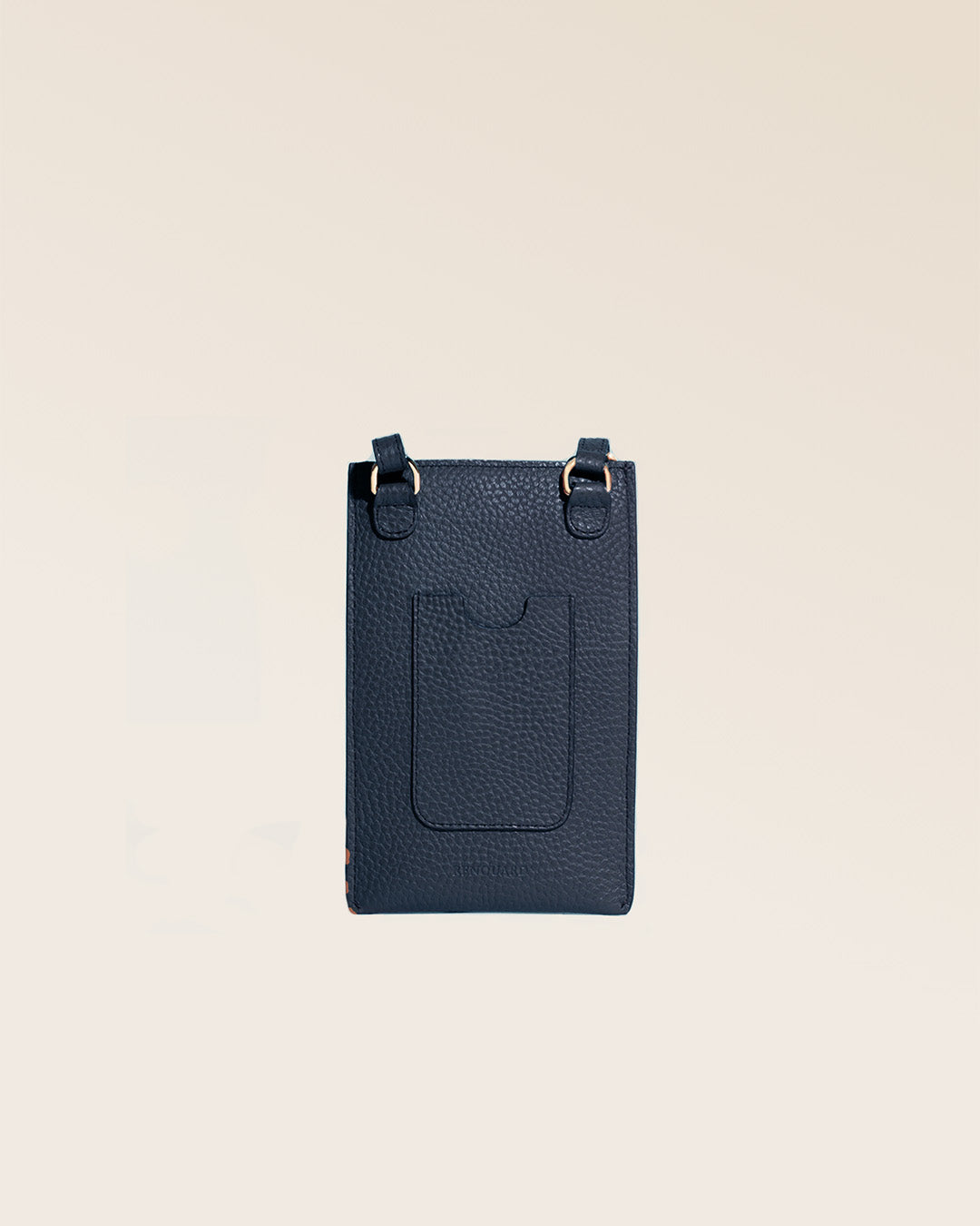 Our Etrivière phone pouch in navy blue vicuña-style leather, seen from the back in the studio.