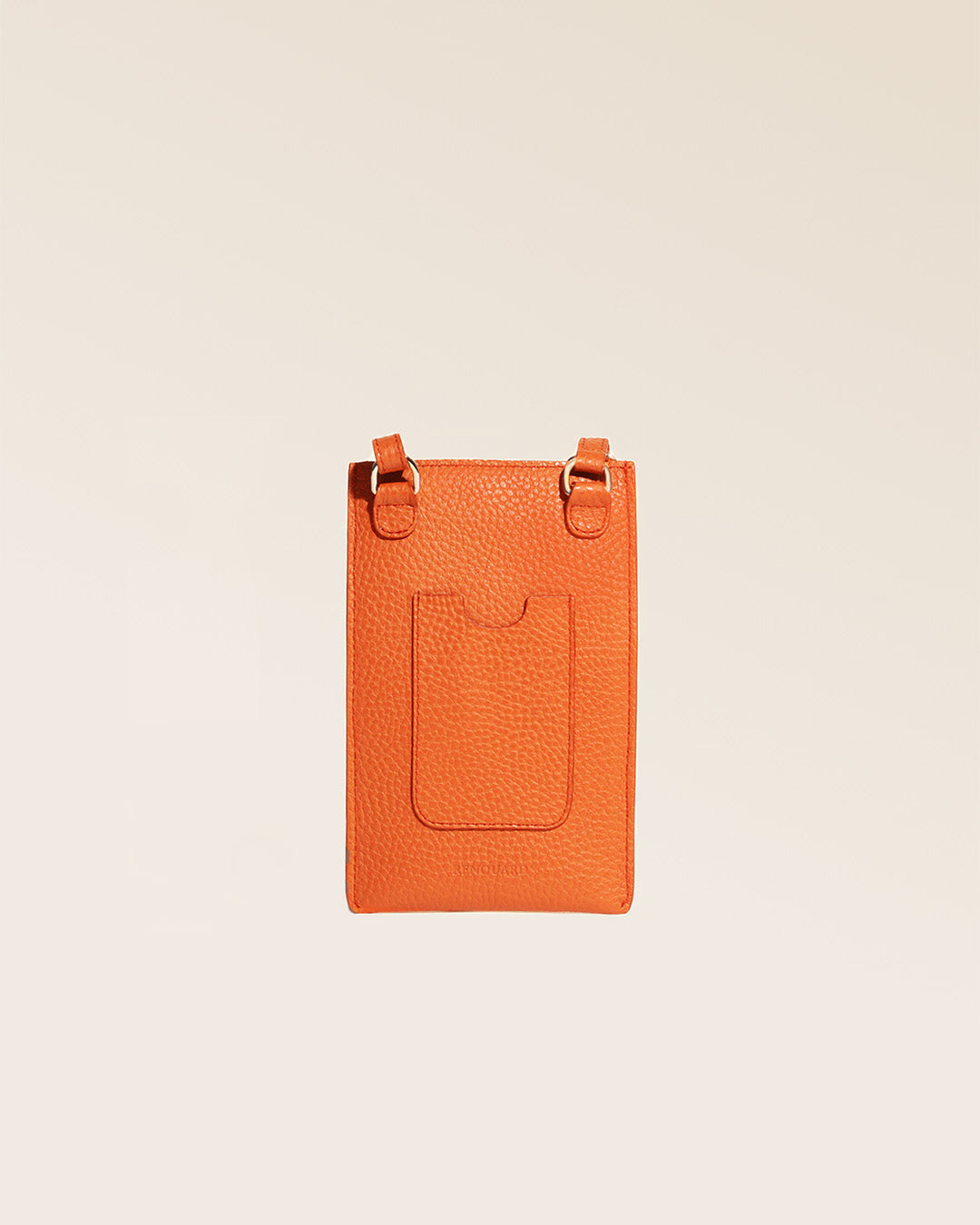 Our Étrivière phone pouch in orange vicuña-style leather, seen from the back in the studio.