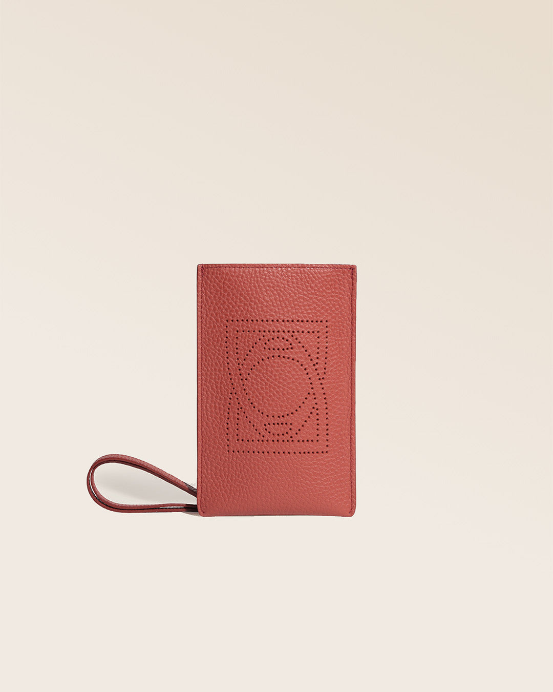 Our Étrivière phone pouch in terracotta vicuña-style leather, seen from the front in the studio.