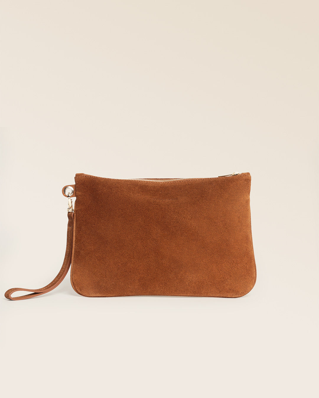 Notre pochette zippée Étrivière en cuir veau velours noisette vu de dos en studio.