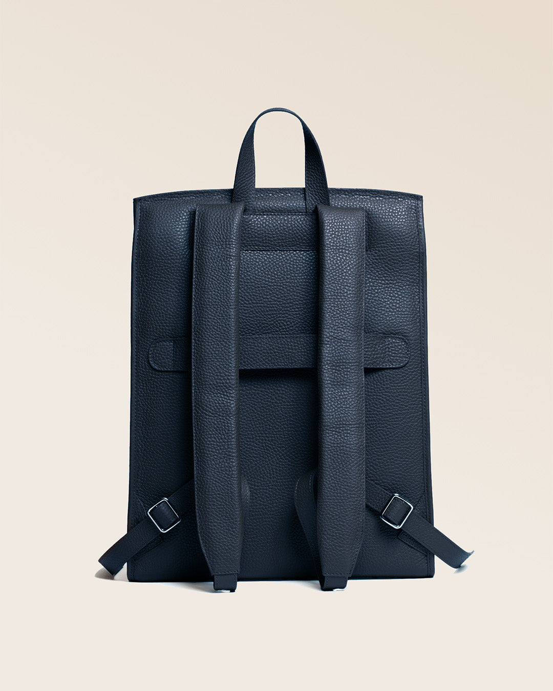 Our Alex backpack in navy blue vicuña-style leather, seen from the back.
