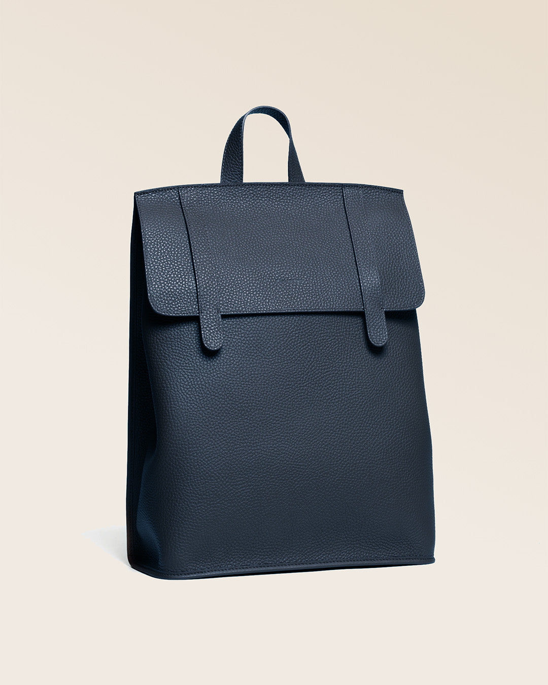 Our Alex backpack in navy blue vicuña-style leather, seen from the quarter.