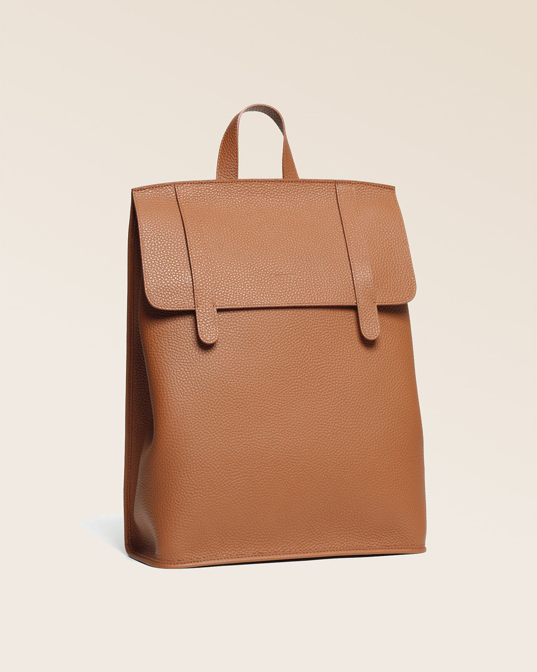 A quarter view of our Alex backpack in fawn-colored vicuña leather.