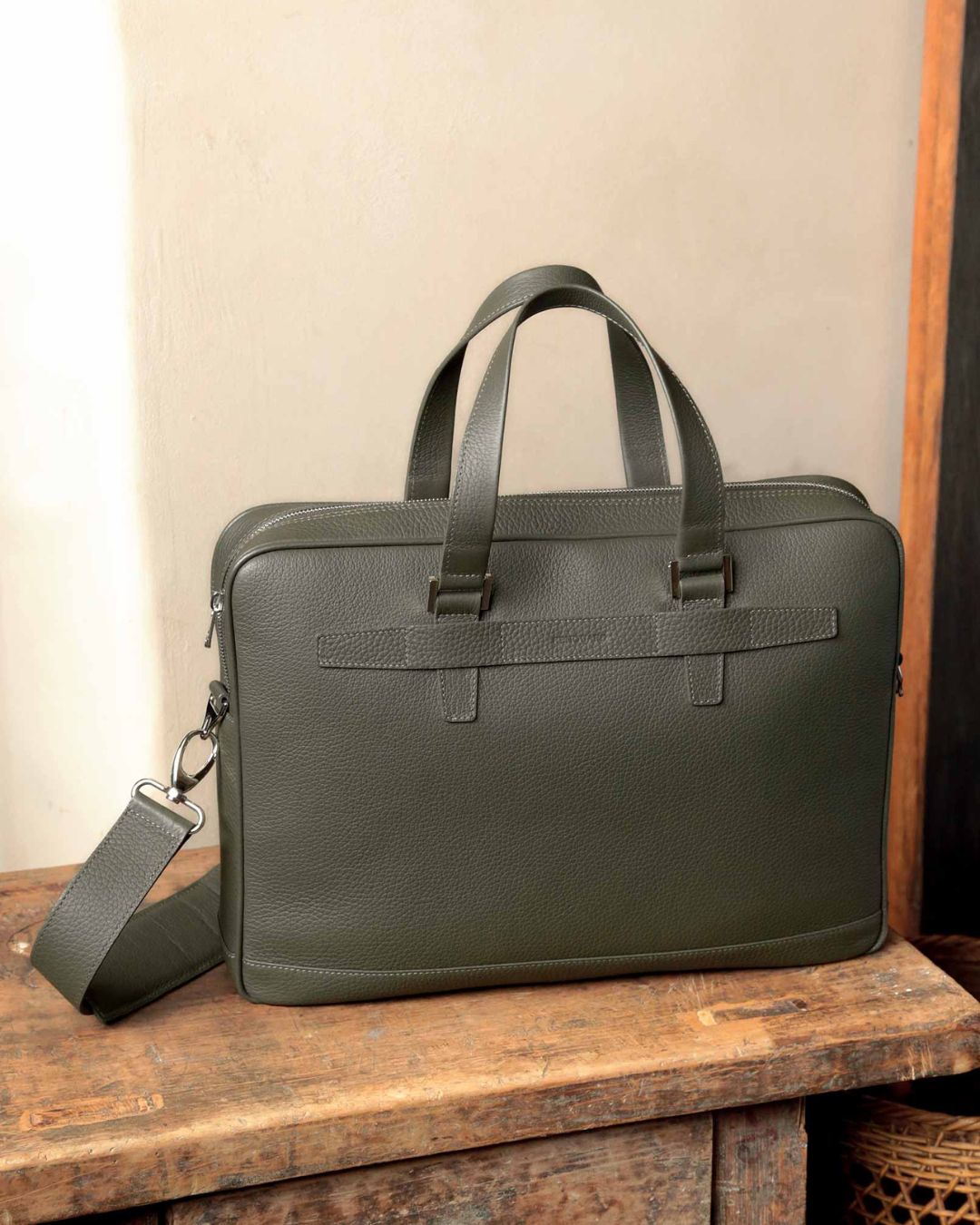 Our Boston satchel bag in khaki vicuña-style leather, seen from the front in ambience.