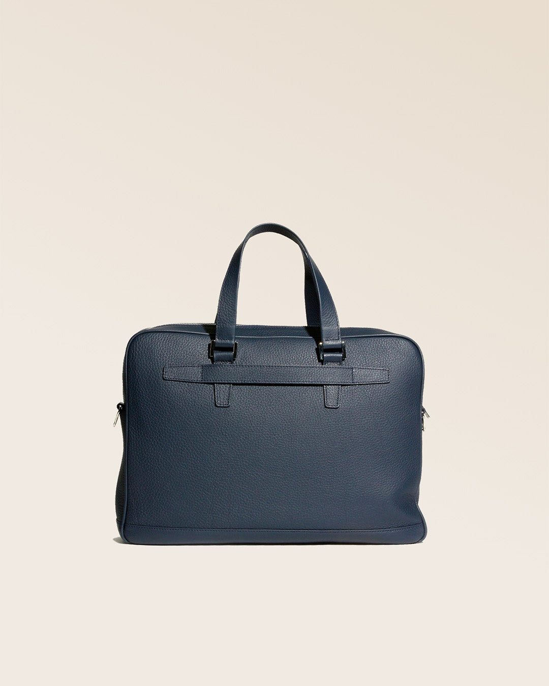 Our Boston satchel bag in navy blue vicuña-style leather, seen from the back in the studio.