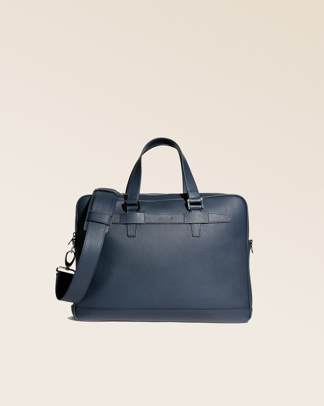 Our Boston satchel bag in navy blue vicuña-style leather, seen from the front in the studio.