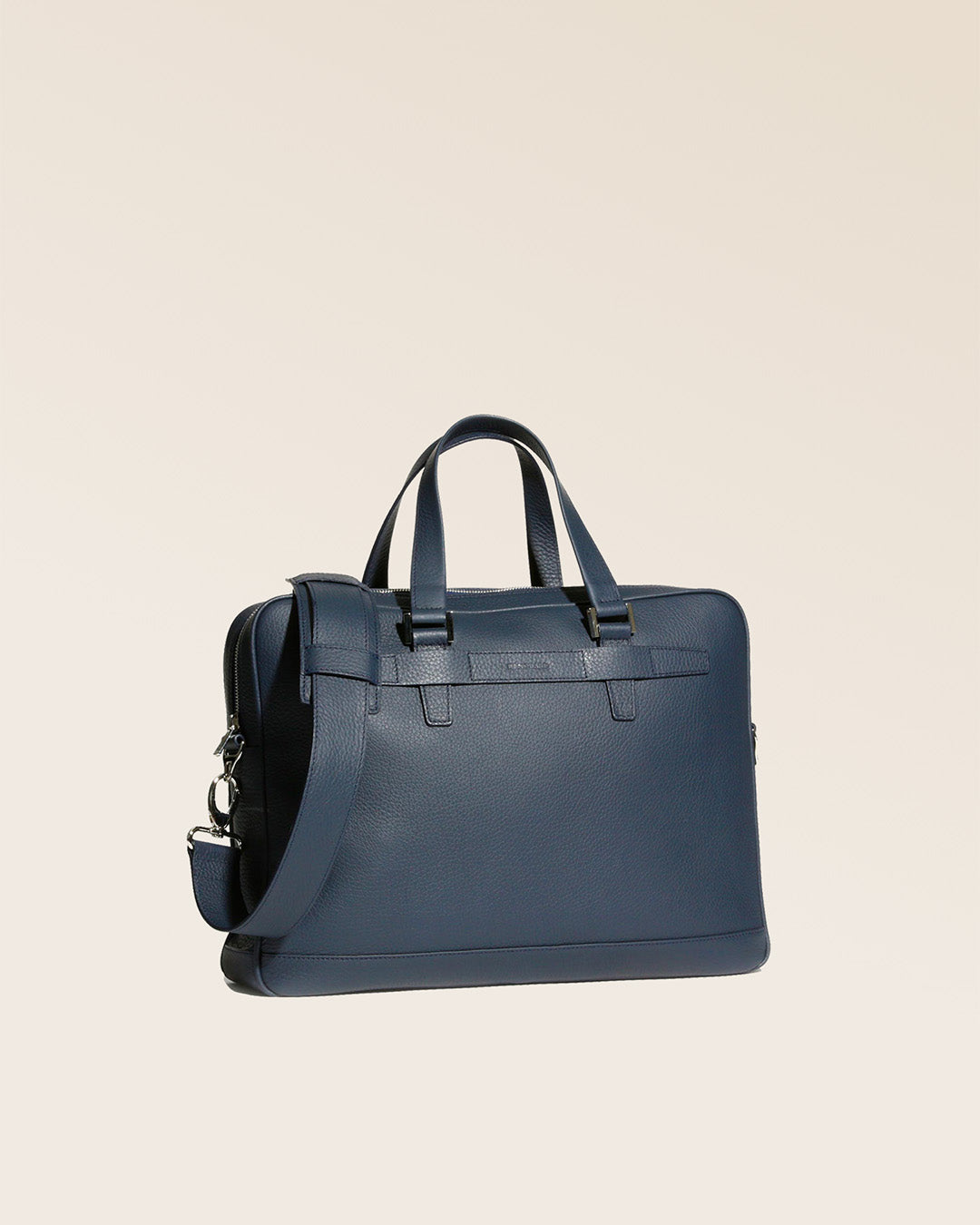 Our Boston satchel bag in navy blue vicuña-style leather, seen from the quarter in the studio.
