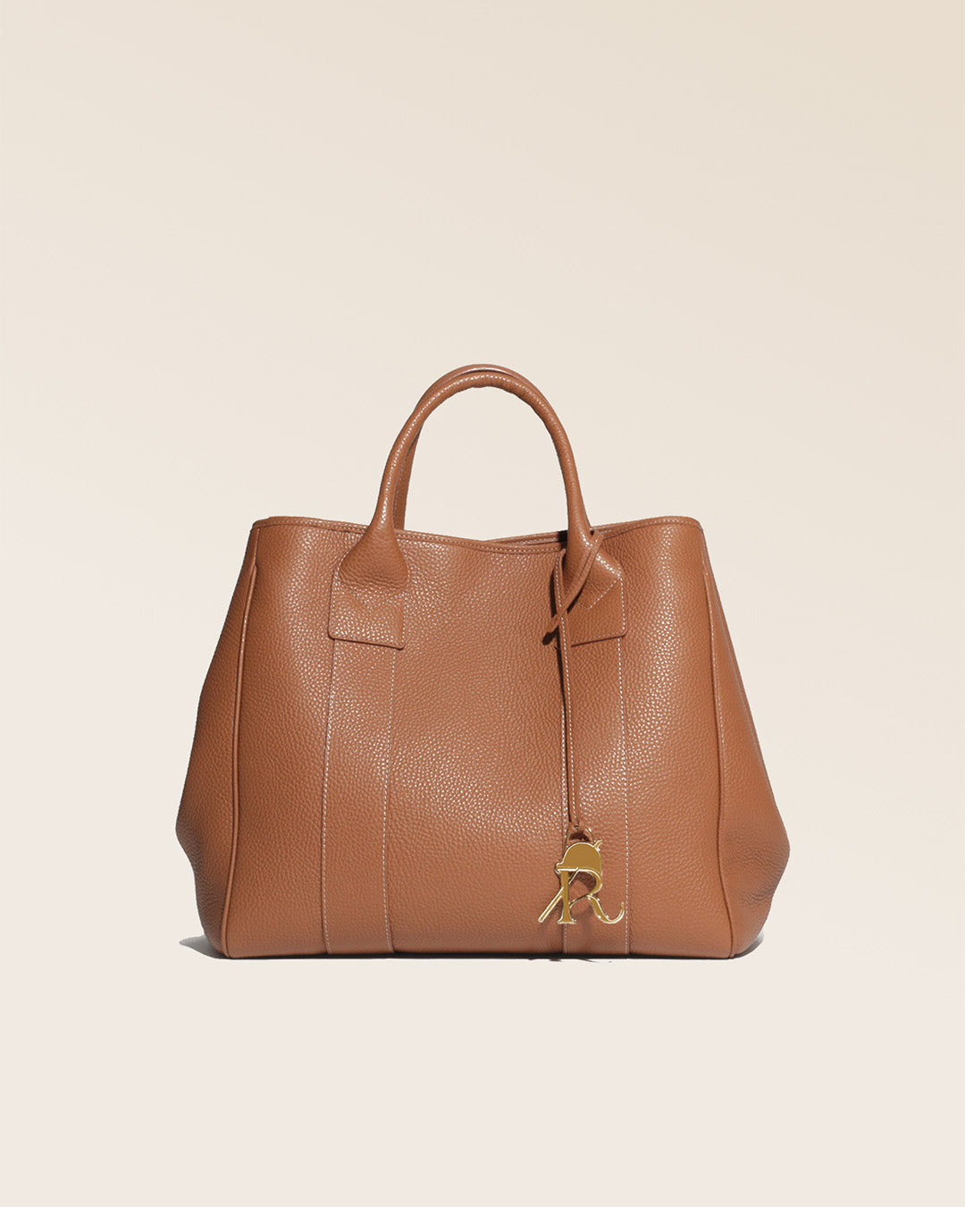 Our Max tote bag in fawn-colored vicuña leather, seen from the front in the studio.