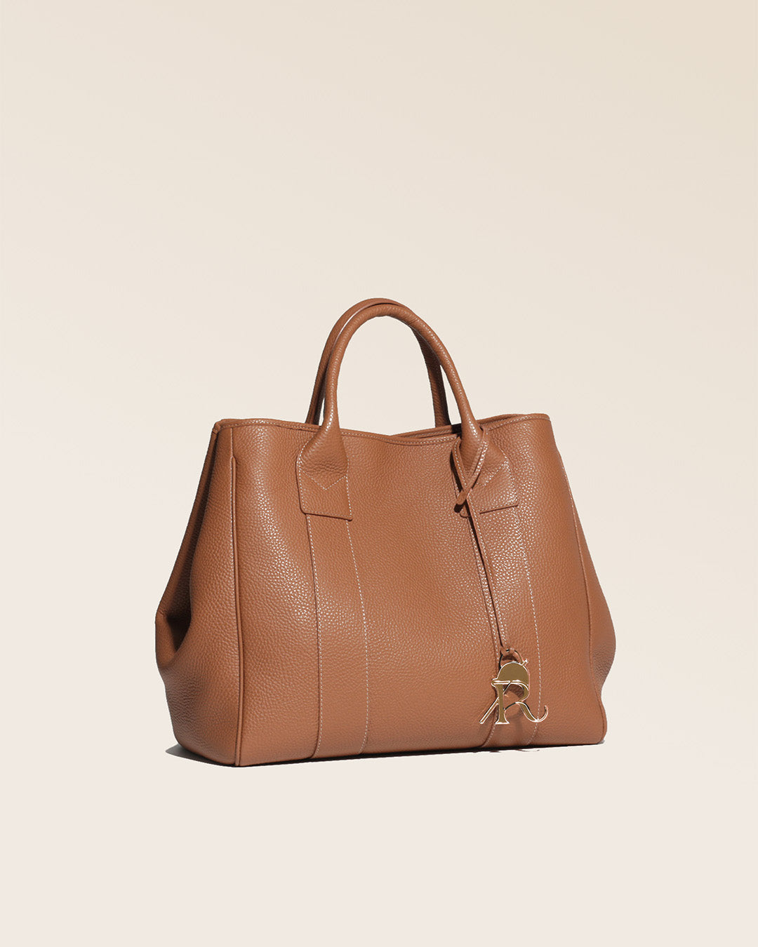 Our Max tote bag in fawn-colored vicuña leather, seen from the quarter in the studio.