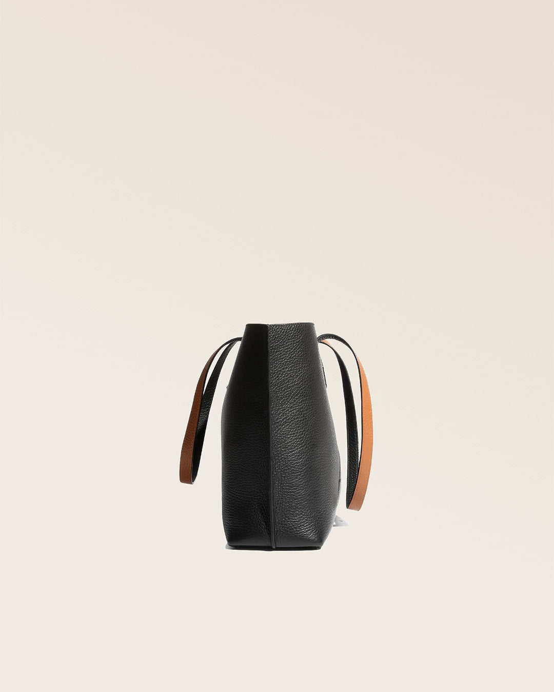 A side view of our Shopper tote bag in black and fawn vicuña-style leather.
