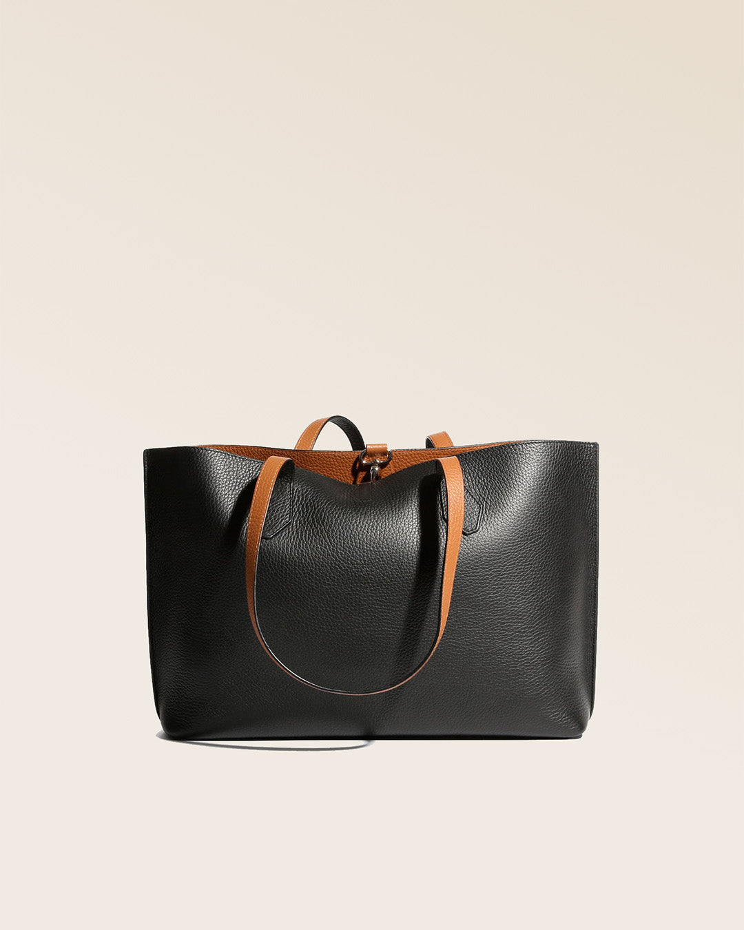 Our Shopper tote bag in black and fawn vicuña-style leather, seen from the back.