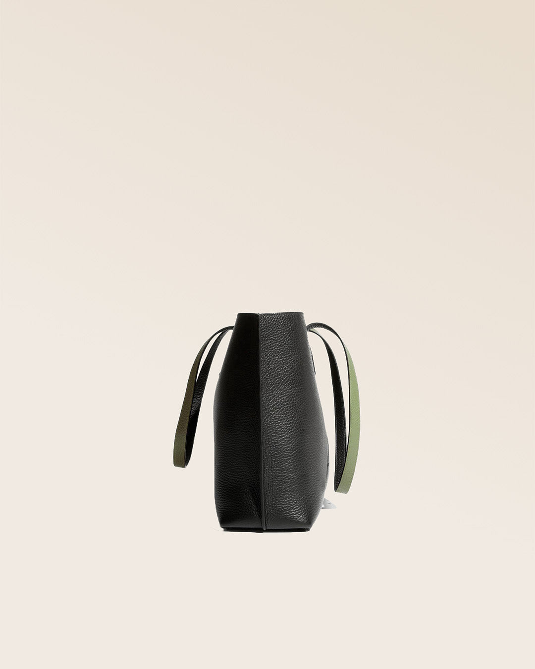 Our Shopper tote bag in black and khaki vicuña-style leather, seen from the side.