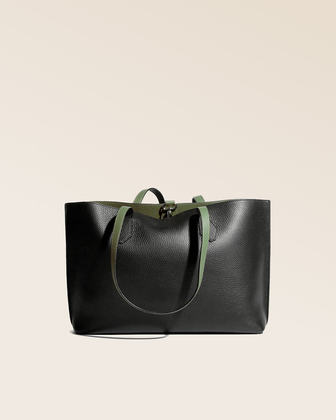 Our Shopper tote bag in black and khaki vicuña-style leather, seen from the back.