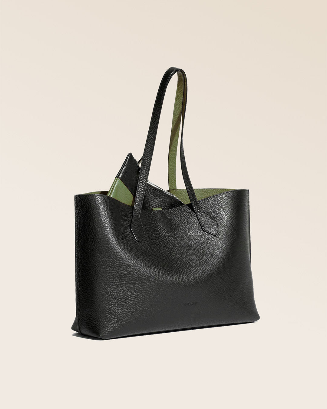 Our Shopper tote bag in black and khaki vicuña-style leather, seen from the quarter.