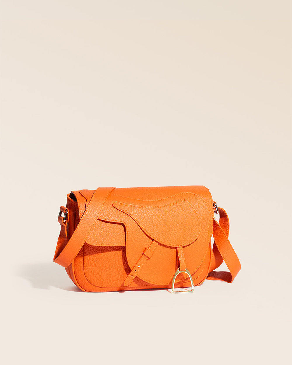 Our orange vicuña-style leather Casaque bag seen from the quarter in the studio.