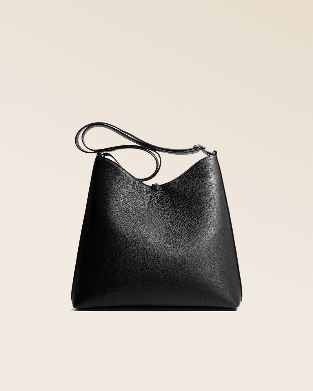 Our large Cob bag in black vicuña-style leather, seen from the back in the studio.