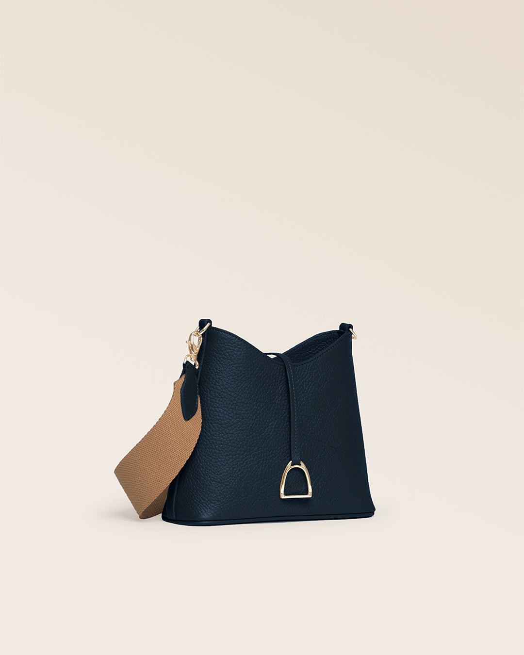 Our Cob Renouard bag in its Mini version, with navy blue vicuña-style leather and cotton shoulder strap; seen from the quarter in the studio.