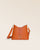 Our Cob Renouard bag in its Mini version, orange vicuña-style leather and leather shoulder strap; seen from the front in the studio.
