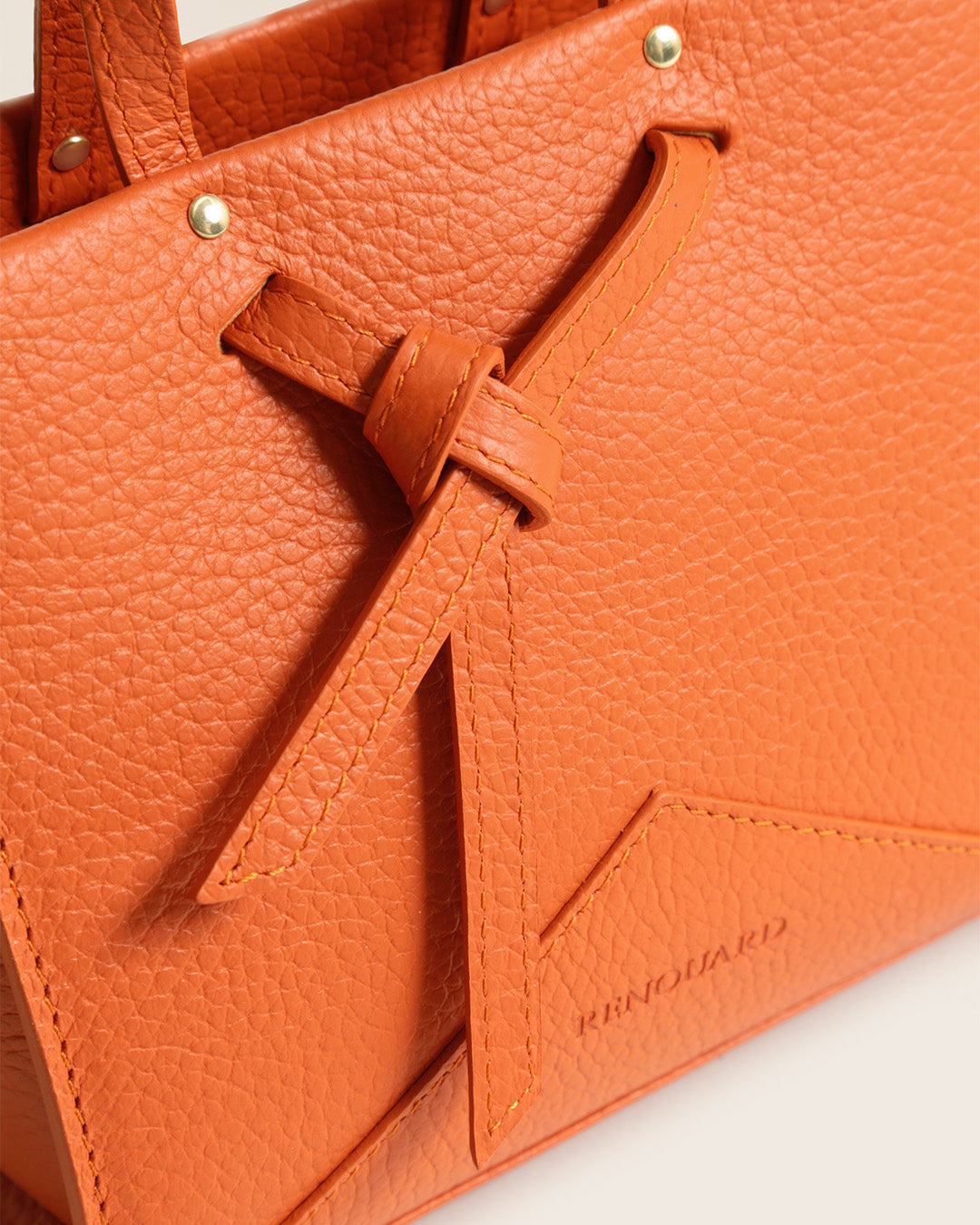 Our Renouard orange vicuña-style leather Croisière bag seen up close in the studio.