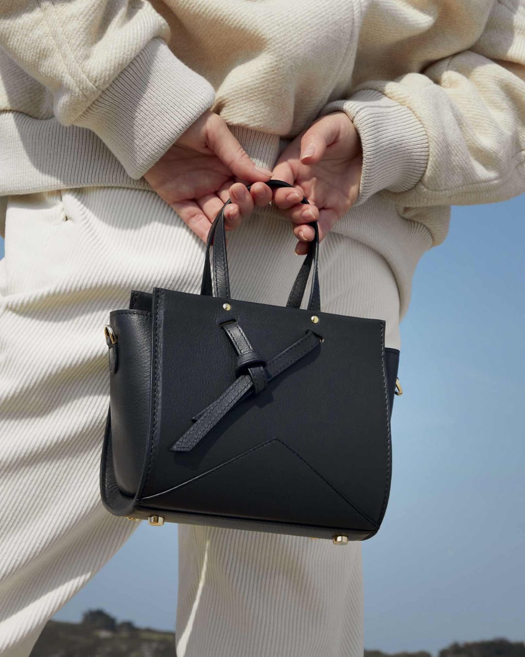 Our Croisière bag in smooth black leather as seen on our model.