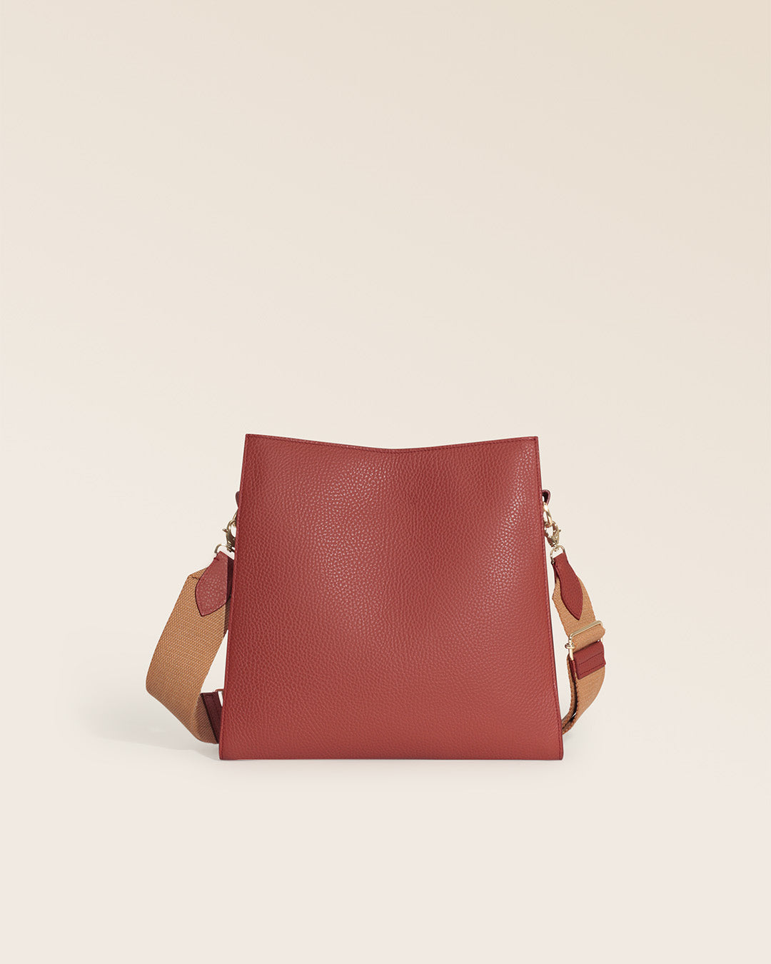 Our Étrivière Renouard bag in terracotta vicuña-style leather and camel cotton shoulder strap, seen from the back in the studio.