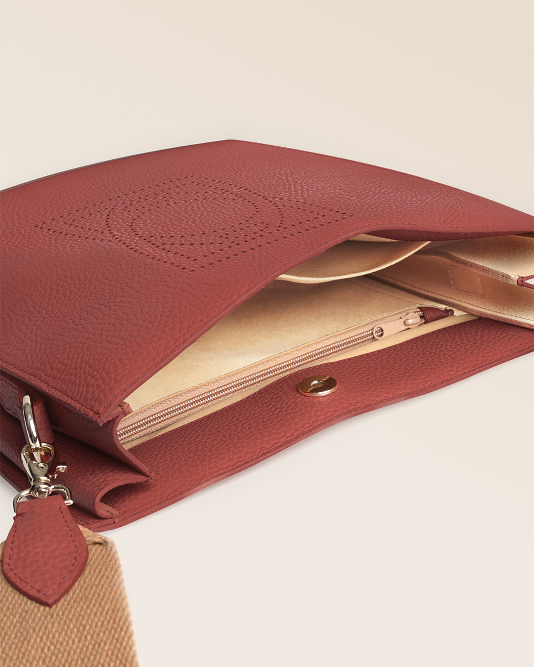 Our Étrivière Renouard bag in terracotta vicuña-style leather and camel cotton shoulder strap, seen open in the studio.