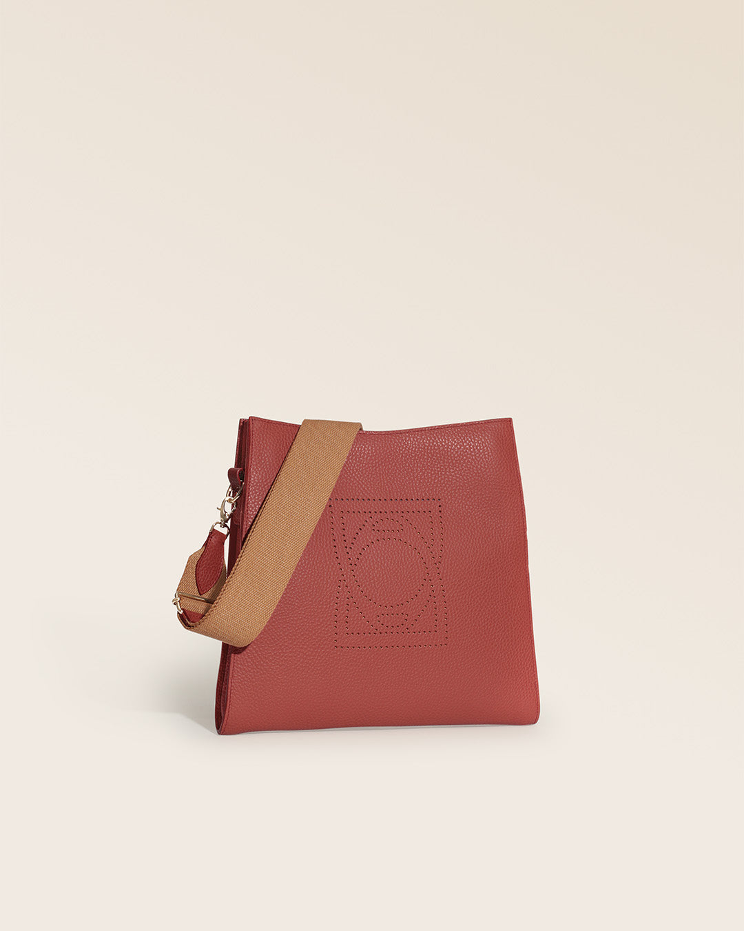 Our Étrivière Renouard bag in terracotta vicuña-style leather and camel cotton shoulder strap, seen from the quarter in the studio.