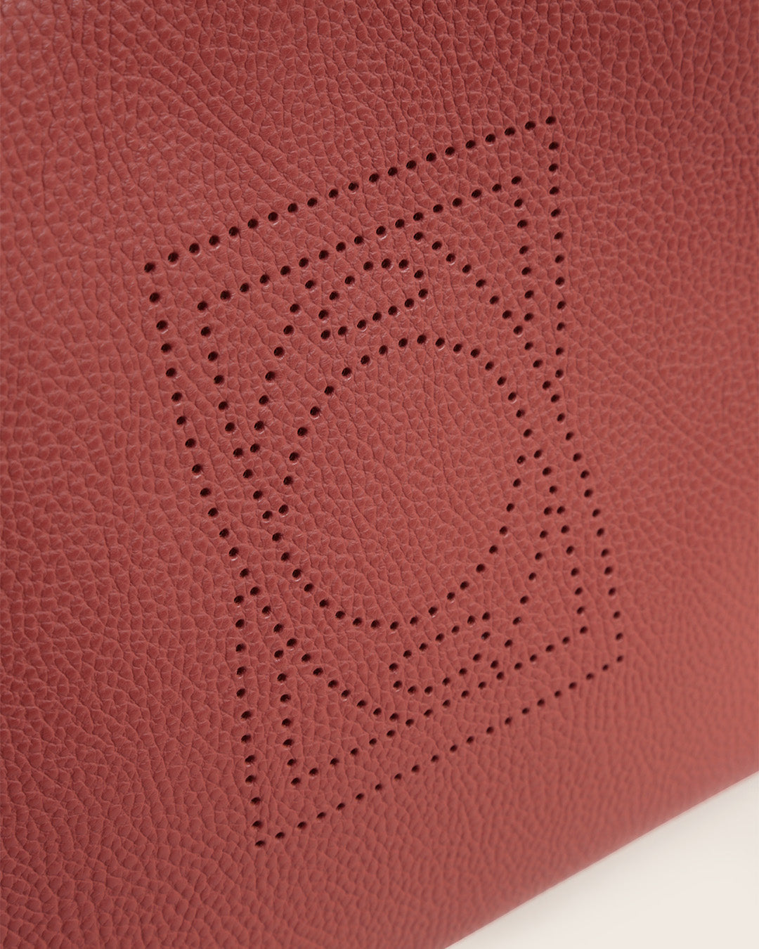 Our Étrivière Renouard bag in terracotta vicuña-style leather and camel cotton shoulder strap, seen in detail in the studio.