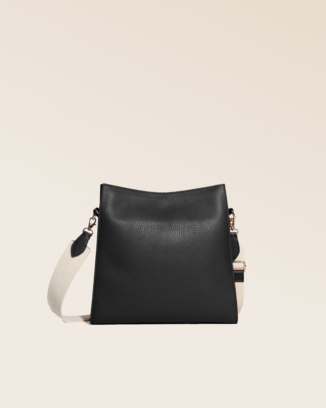 Notre sac Étrivière petit modèle en cuir façon vigogne noir et bandoulière coton vu de dos en studio.