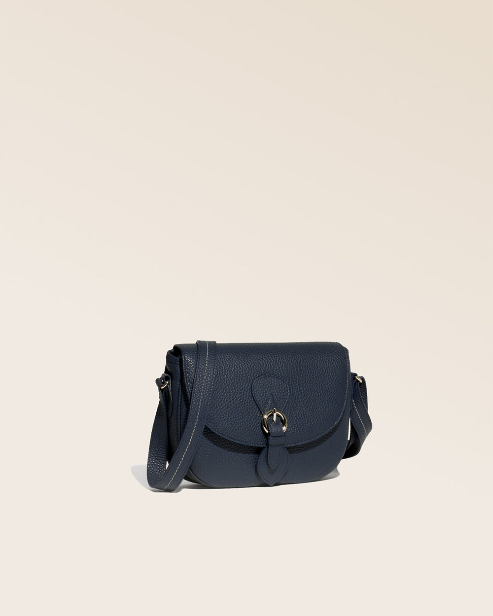 Our navy blue vicuña-style leather Lea satchel bag, seen from a quarter in the studio.