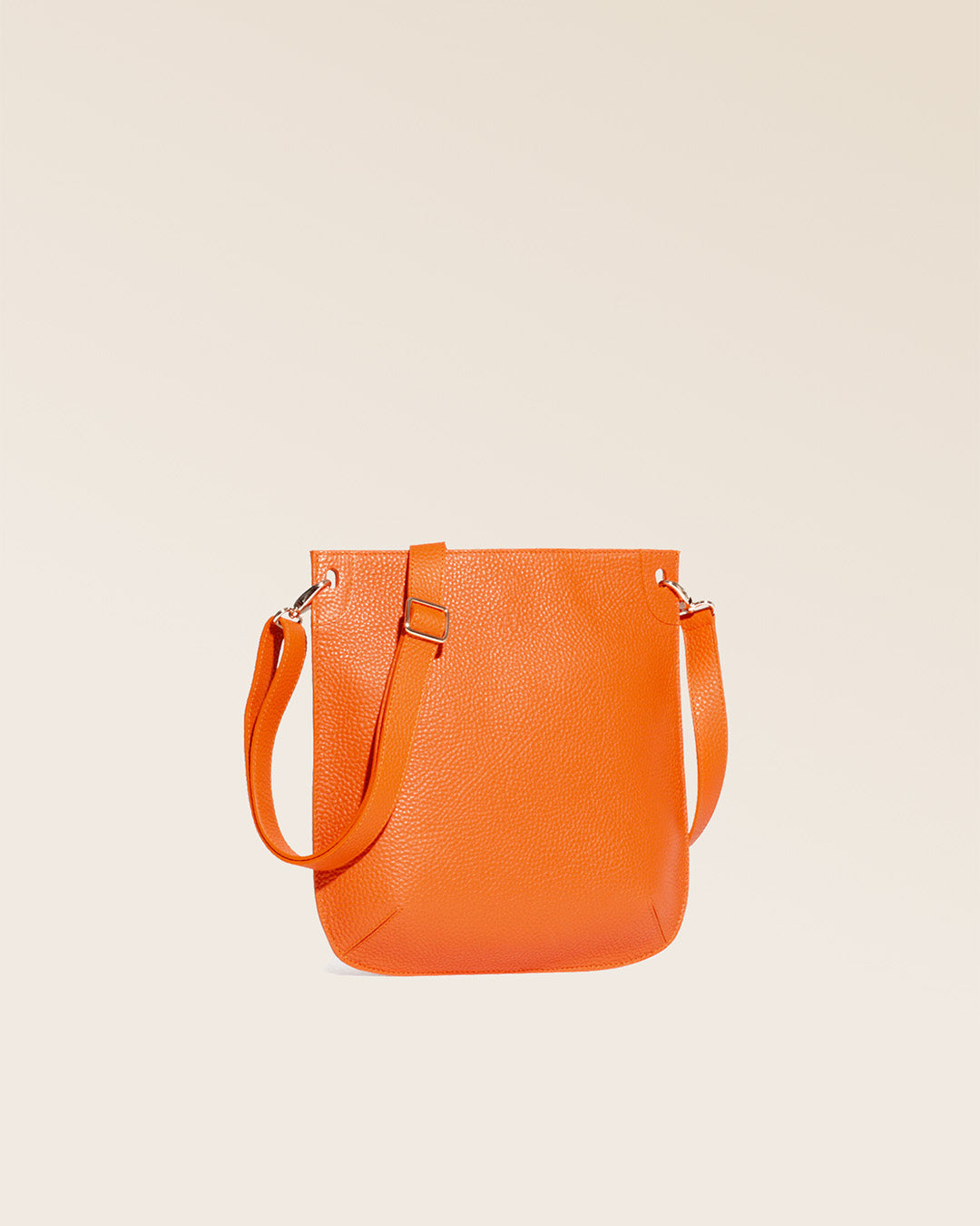 Notre sac Harnais en cuir façon vigogne orange vu de quart en studio.