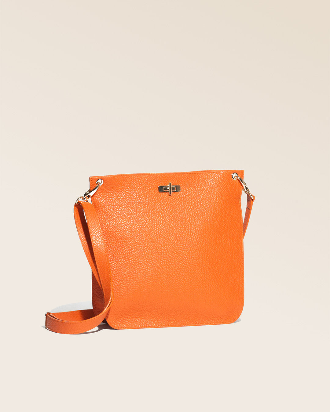 A quarter view of our Hermine bag in orange vicuña-style leather.