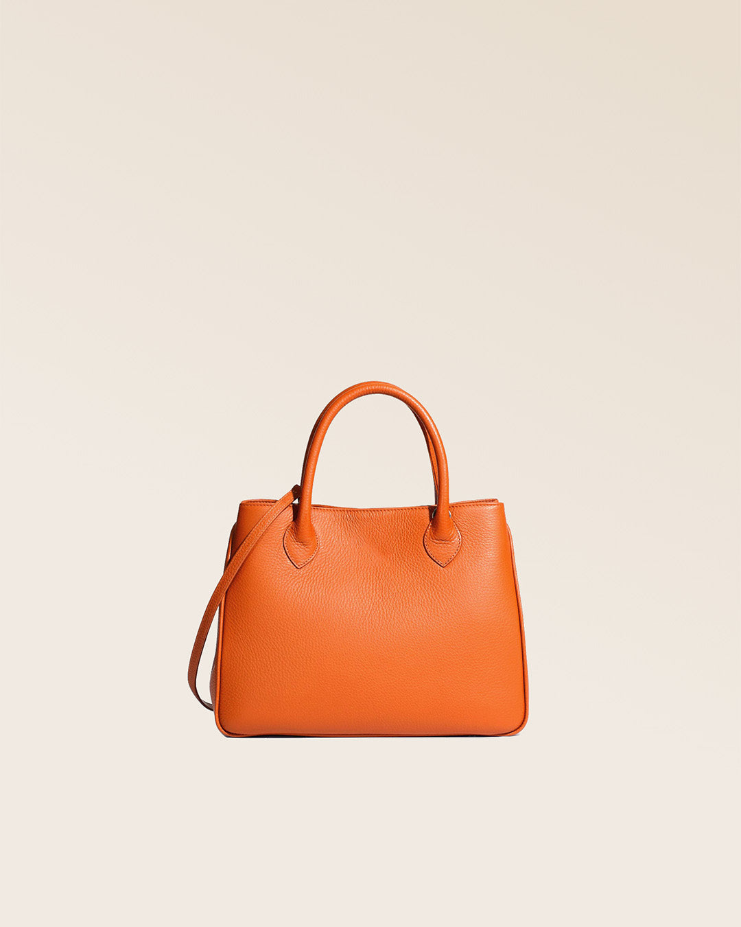 Our Ker Balmoral bag in orange vicuna-style leather, seen from the back in the studio.