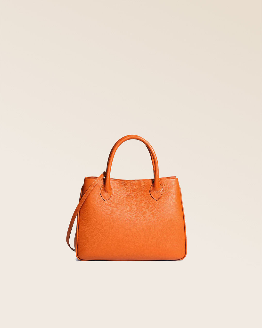 Our Ker Balmoral bag in orange vicuna-style leather, seen from the front in the studio.