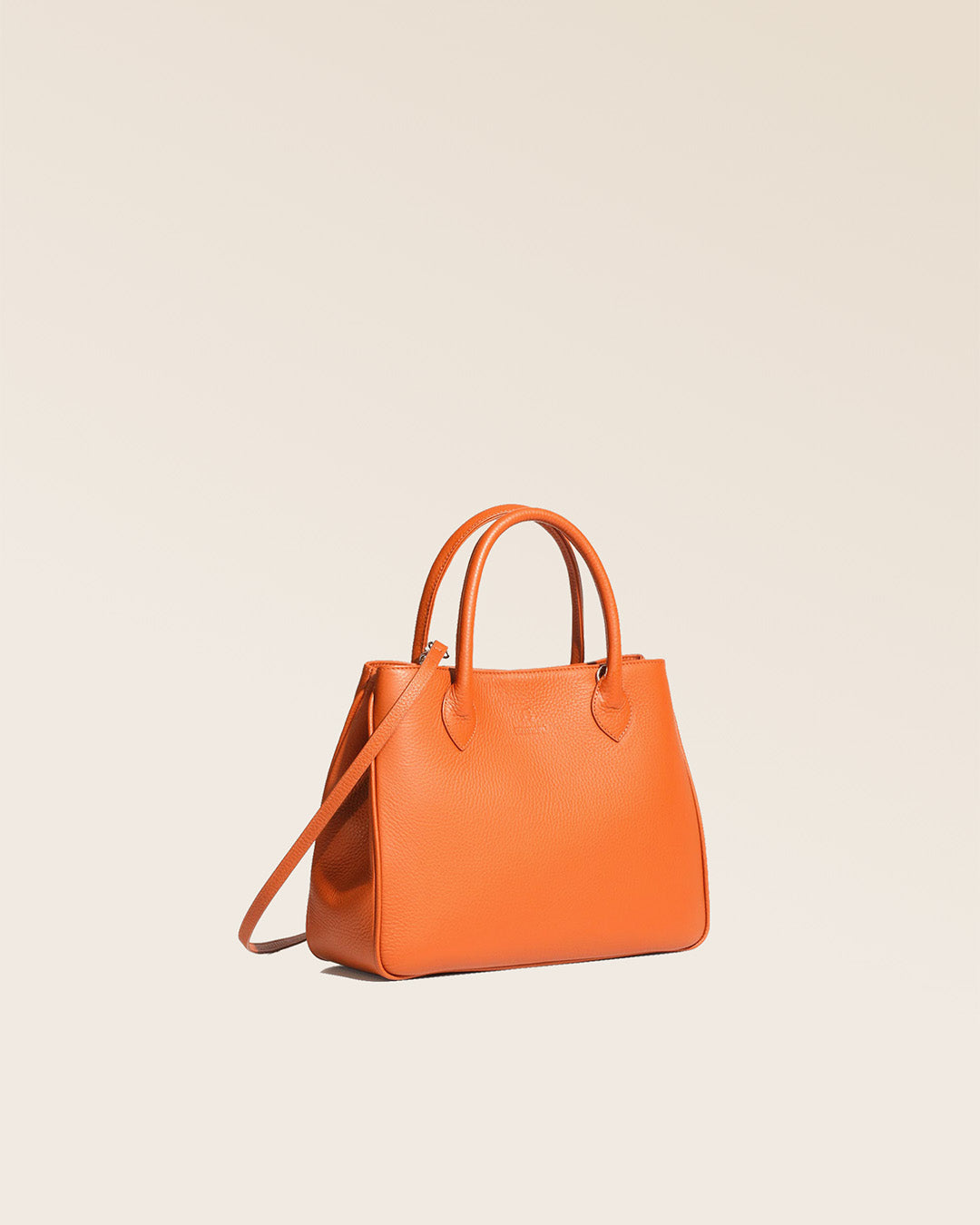 Our Ker Balmoral bag in orange vicuña-style leather, seen from the quarter in the studio.
