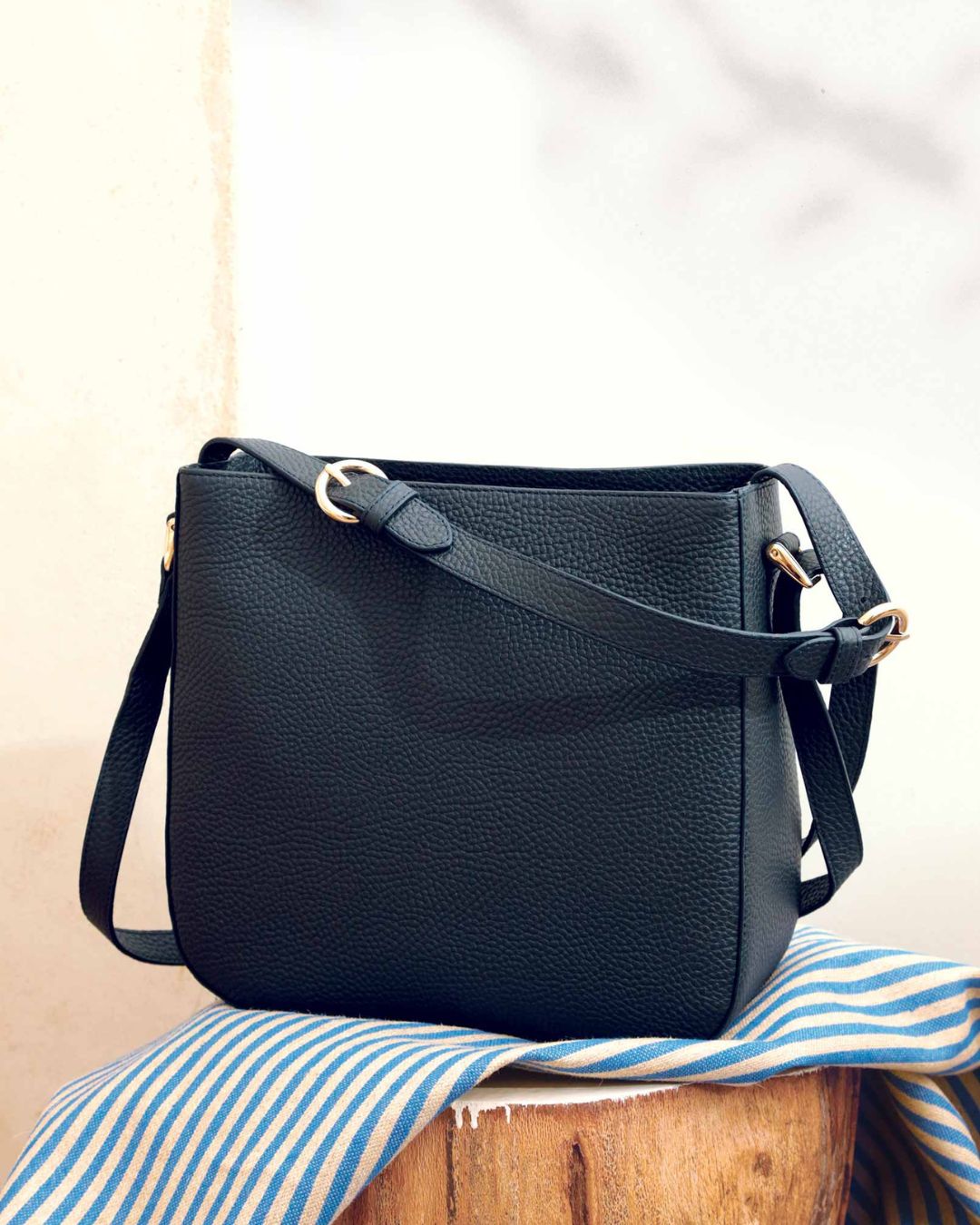 Notre sac Marlow en cuir façon vigogne bleu marine vu de face en ambiance.