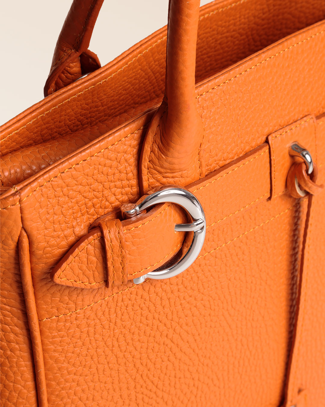 Notre sac Prestige Renouard, dans sa version Mini, en cuir façon vigogne orange , vu en détail en studio.