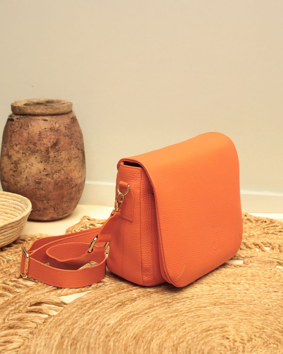 Our Samuel bag in orange vicuña-style leather, seen from the quarter.