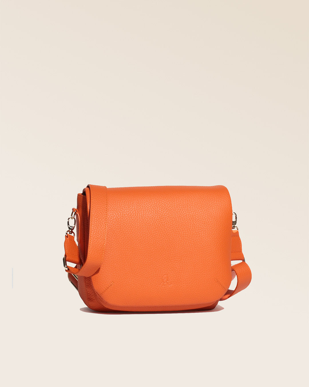 Our Samuel bag in orange vicuña-style leather, seen from the quarter in the studio.