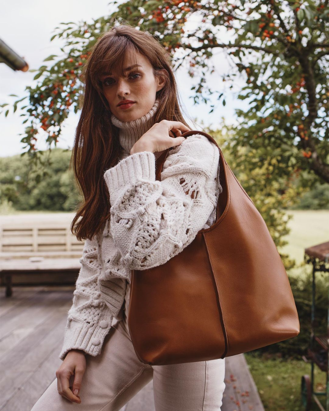 Our Valentine Renouard bag, in vintage camel leather, seen worn by our model.