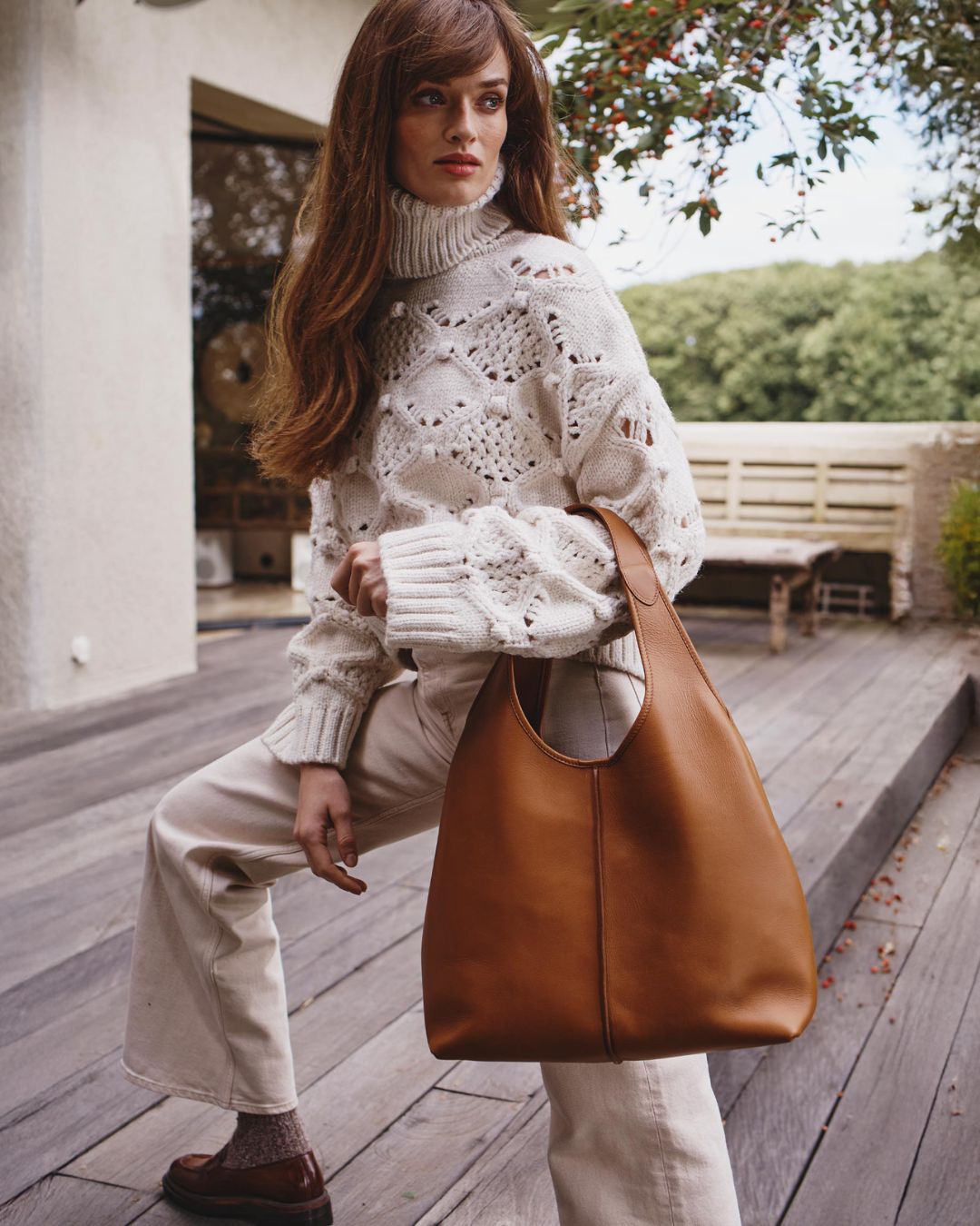Our Valentine Renouard bag, in vintage camel leather, seen worn at the elbow by our model.