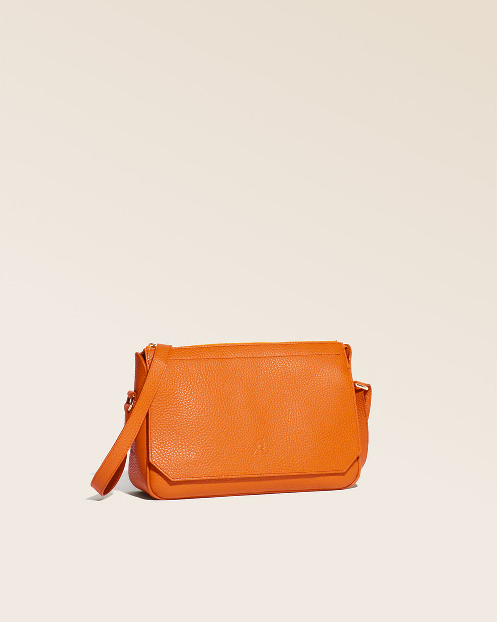 A quarter view of our Vendôme bag in orange vicuña-style leather.