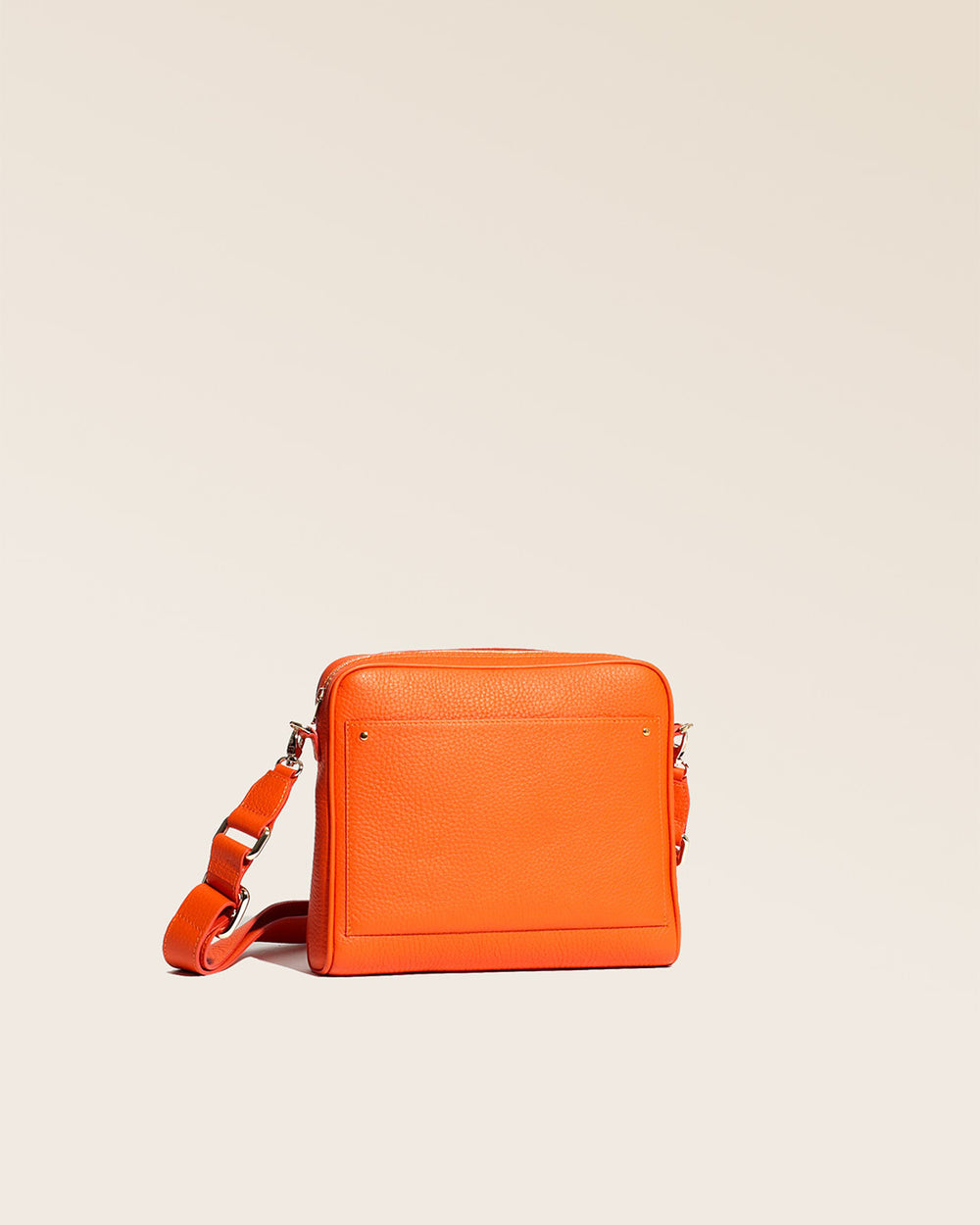 Our Zoom bag in orange vicuña-style leather with leather shoulder strap as seen from the studio.
