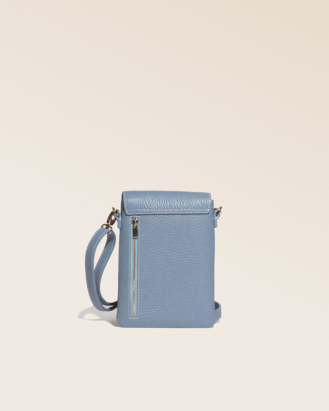 Our Gull clutch bag in cobalt-blue vicuña-style leather, seen from the back in the studio.